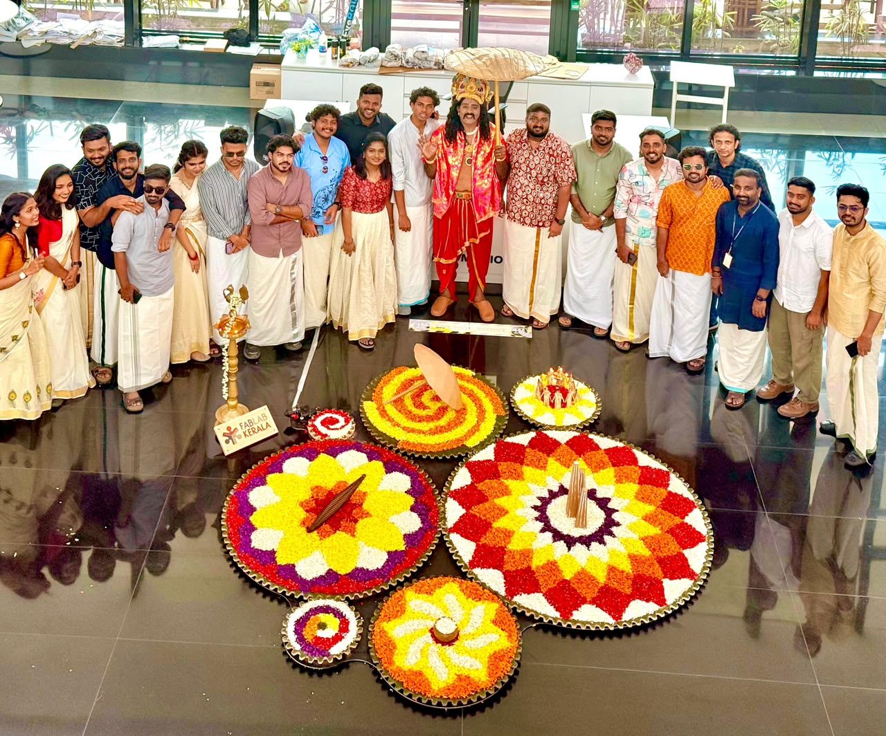 Mahabali with the team, around a floor of finished pookalams.